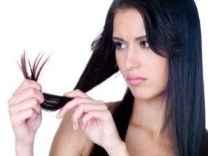 Woman looking at her Split Ends